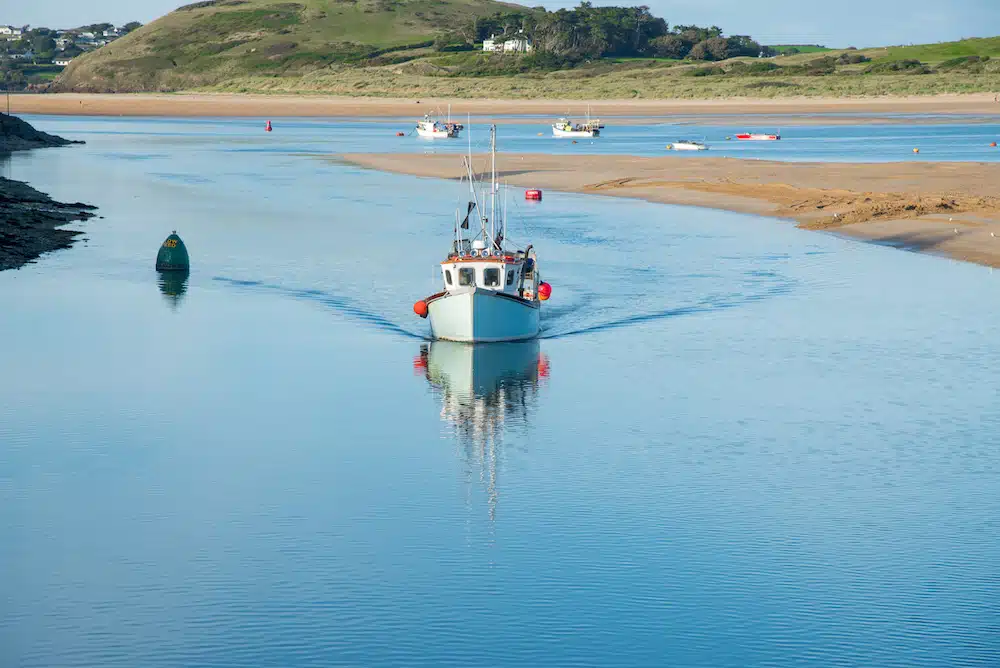 Fishing boat arrives in the port of Padstow at the Camel estuary in north Cornwall