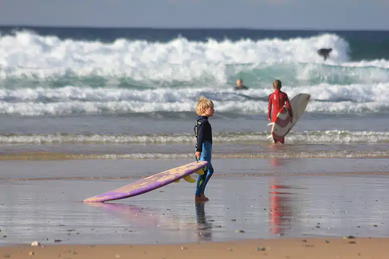 Children learning to surf at Watergate Bay