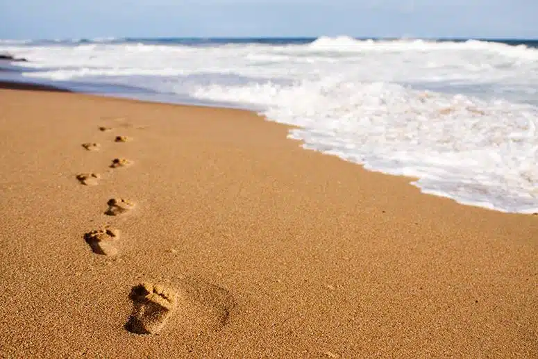 Quiet beach with footprints in the sand