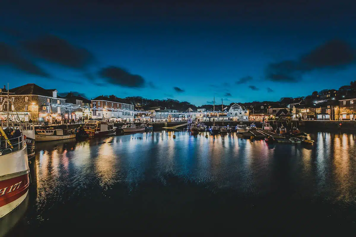 Padstow harbour at night lit by the festival lights. Copyright Adam Sargent.
