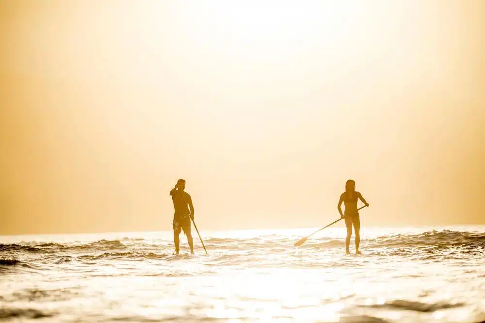 SUP couple on sea