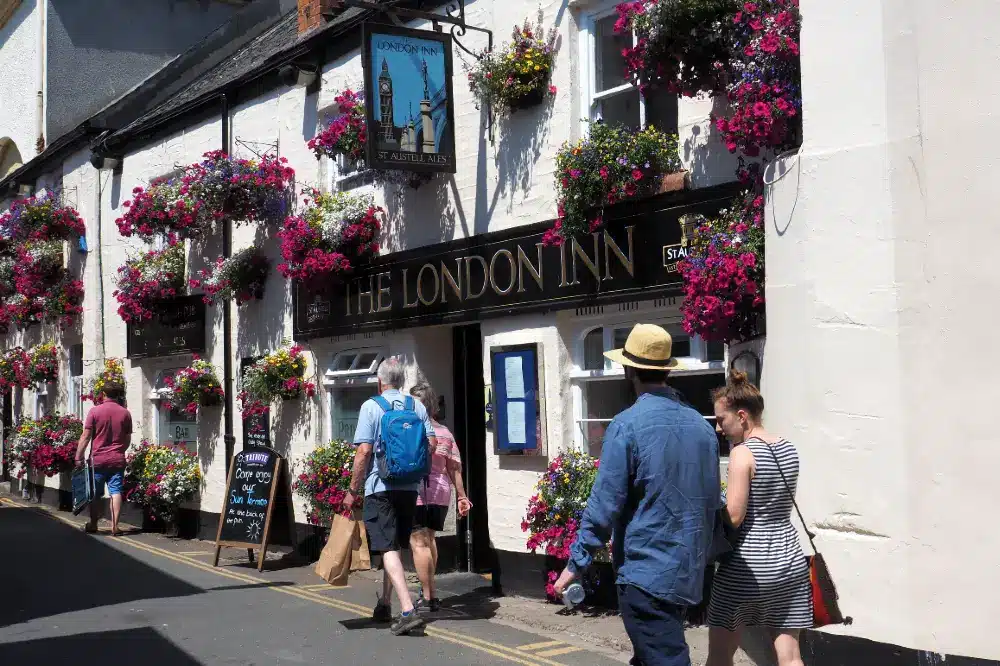 Pub with flower baskets in bloom in Padstow Cornwall
