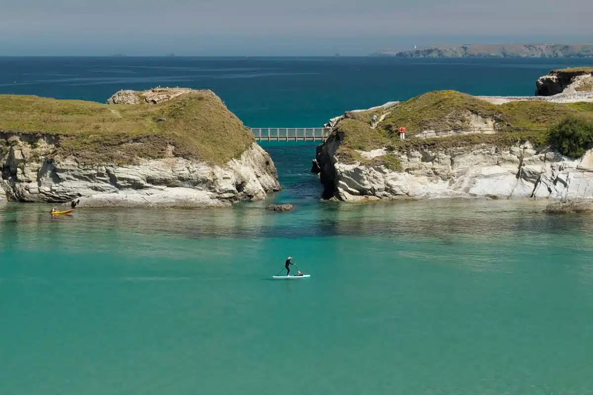 Stand up paddle boarder at Porth, Cornwall