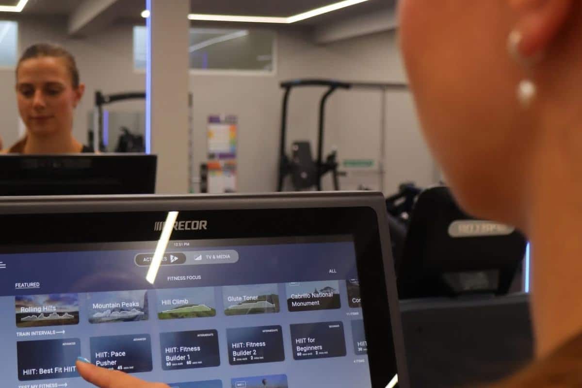 Woman using fitness machine at Office Gym Club