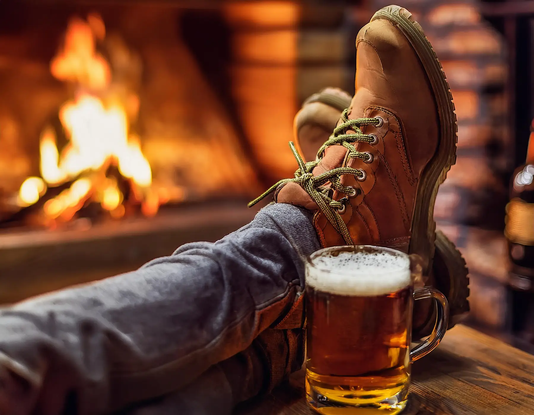 hiking boots and pint beside a pub fire